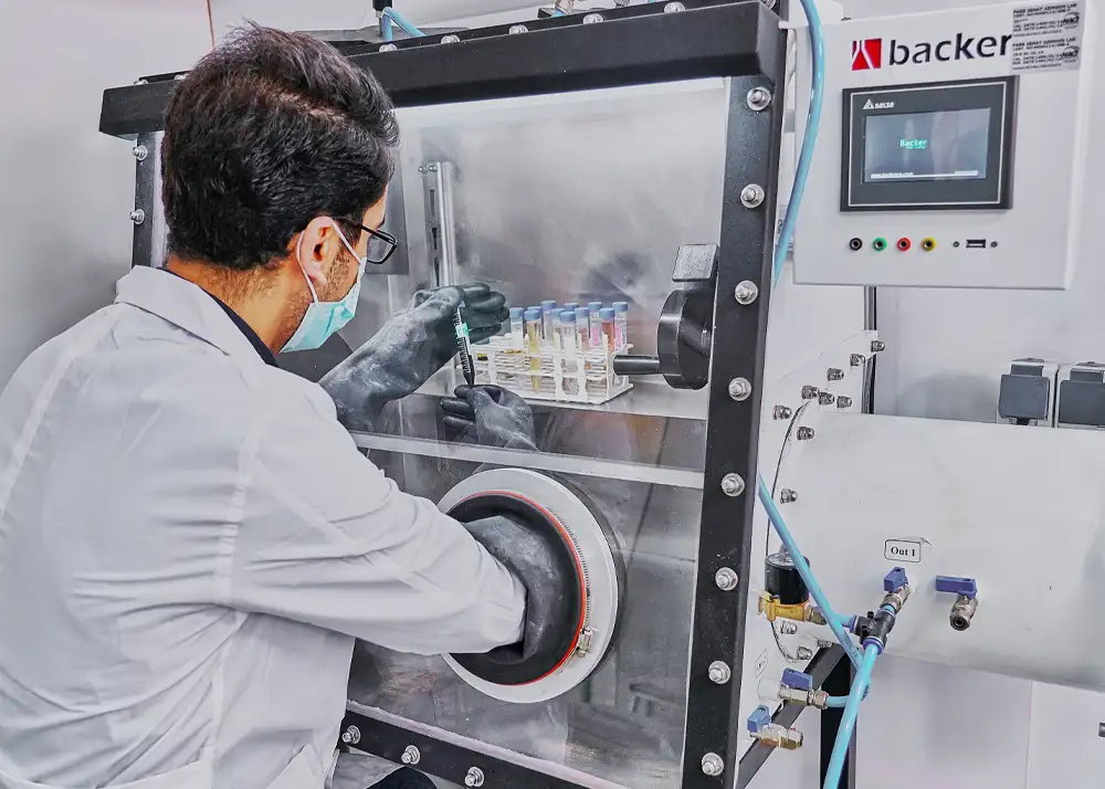 Researcher performing precise sample testing in a controlled environment.